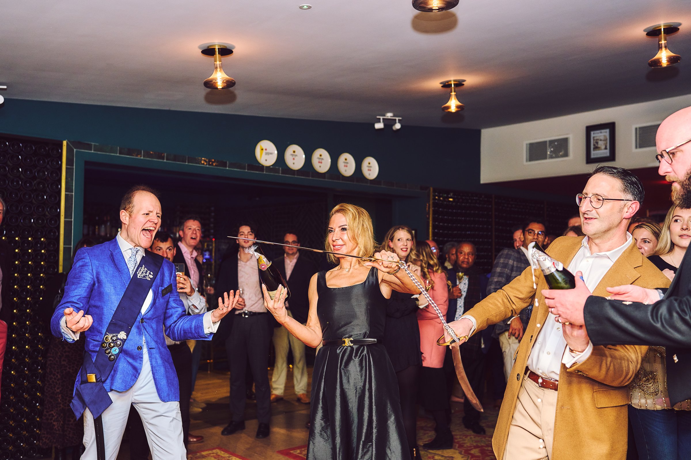 Member performing sabrage at our launch party at Squerryes