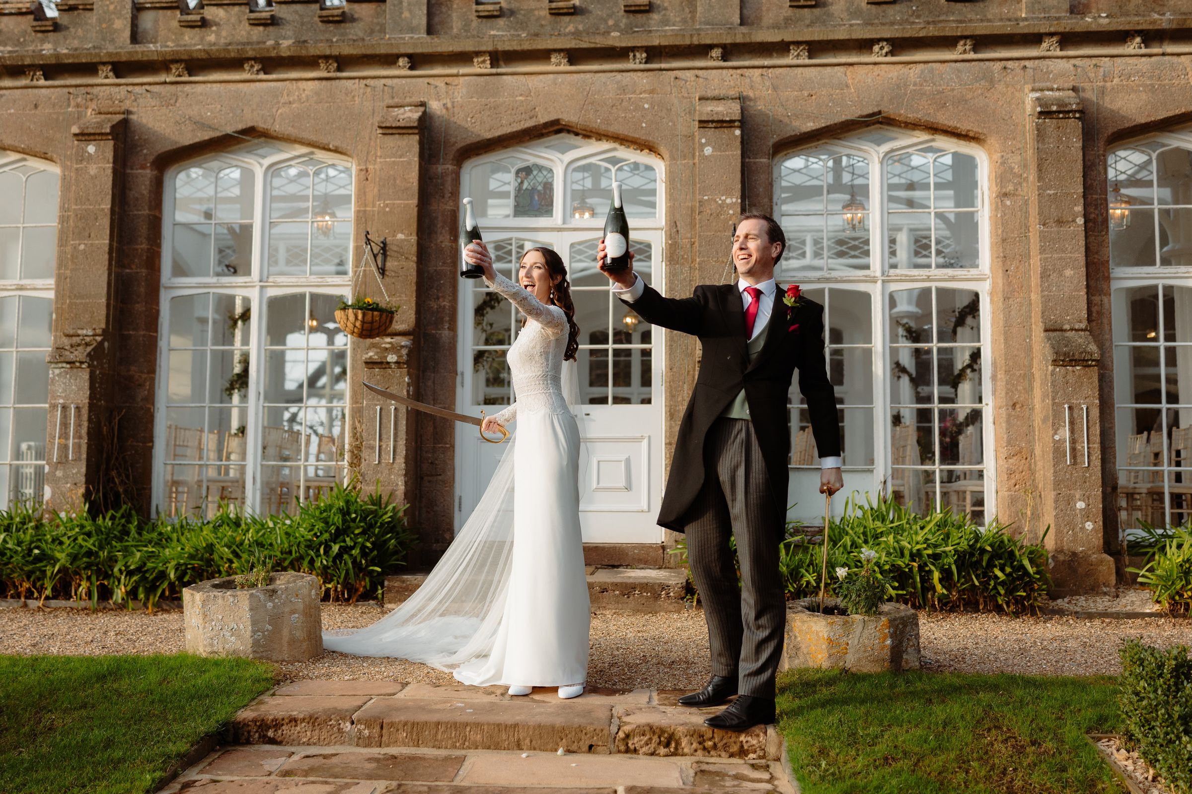 Sabrage at a wedding — couple celebrating with English sparkling wine